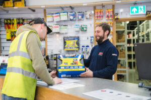 A BEW employee showing a customer a product at a trade counter